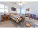 Bedroom with plaid bedding, space-themed rug, and bright natural light at 3440 Caleb Rd, Snellville, GA 30039