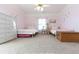 Pink bedroom featuring two twin beds, wicker furniture, and ample space at 3440 Caleb Rd, Snellville, GA 30039