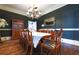 Formal dining room with hardwood floors, large table, and elegant chandelier at 3440 Caleb Rd, Snellville, GA 30039