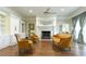 Elegant living room with hardwood floors, fireplace, built-in shelves, and seating at 3440 Caleb Rd, Snellville, GA 30039