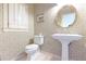 Charming powder room with floral wallpaper, pedestal sink, and round mirror at 3440 Caleb Rd, Snellville, GA 30039