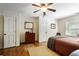 Traditional bedroom with hardwood floors, ceiling fan, closet, and large window for natural light at 415 S Woodland Sw Dr, Marietta, GA 30064