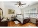 Serene bedroom features hardwood floors, a cozy bed, and bright natural light from the large windows at 415 S Woodland Sw Dr, Marietta, GA 30064