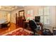 Bedroom featuring hardwood floors, a workspace, and great natural light from plantation-shuttered windows at 415 S Woodland Sw Dr, Marietta, GA 30064