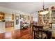 Bright dining area with hardwood floors, a glass table, and adjacent to a modern kitchen at 415 S Woodland Sw Dr, Marietta, GA 30064