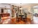 Charming dining area with hardwood floors, a glass table, and views of the dining room at 415 S Woodland Sw Dr, Marietta, GA 30064