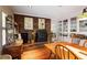 Cozy dining area featuring a brick fireplace, wine-themed decor and built-in storage at 415 S Woodland Sw Dr, Marietta, GA 30064