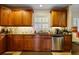 A clean kitchen featuring wooden cabinets, granite countertops, and stainless steel appliances at 415 S Woodland Sw Dr, Marietta, GA 30064