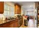 Bright and well-lit kitchen featuring wooden cabinets, granite countertops and stainless steel appliances at 415 S Woodland Sw Dr, Marietta, GA 30064