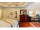 Main bedroom showcasing a large dresser, hardwood floors, tray ceiling and plenty of natural light at 415 S Woodland Sw Dr, Marietta, GA 30064