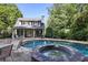 Backyard featuring a sparkling pool and spa, complemented by an outdoor patio with ample seating at 415 S Woodland Sw Dr, Marietta, GA 30064