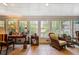 Bright sunroom with large windows, a tiled floor and comfortable wicker seating at 415 S Woodland Sw Dr, Marietta, GA 30064