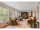 Cozy sunroom with large windows, tiled floor and comfortable wicker furniture at 415 S Woodland Sw Dr, Marietta, GA 30064