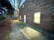 Spacious backyard with a brick exterior and a concrete patio, illuminated by natural light at 342 Mccurry Rd, Stockbridge, GA 30281