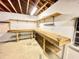 Unfinished basement with workbench and shelving along the perimeter at 342 Mccurry Rd, Stockbridge, GA 30281