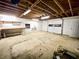 Unfinished basement with exposed ceiling and a large overhead garage door at 342 Mccurry Rd, Stockbridge, GA 30281