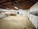 Large unfinished basement with exposed ceiling and garage door at 342 Mccurry Rd, Stockbridge, GA 30281