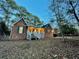 Attractive brick home with a white porch, green shutters, and mature trees at dusk at 342 Mccurry Rd, Stockbridge, GA 30281