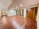 Spacious living room featuring wood-look tile, abundant natural light and wooden entry door at 342 Mccurry Rd, Stockbridge, GA 30281