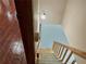 Staircase with carpeted steps and wooden railing, illuminated by a sconce on the wall at 342 Mccurry Rd, Stockbridge, GA 30281