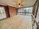 Enclosed sunroom features wooden floors, ceiling fan and multiple windows with views of the backyard at 342 Mccurry Rd, Stockbridge, GA 30281