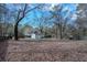 Expansive backyard with a shed, mature trees, a wood fence, and seasonal foliage at 4985 Union St, Union City, GA 30291