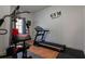 Workout room featuring a weight machine, treadmill, hardwood floors, and a 