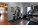 Workout room featuring a weight machine, treadmill, hardwood floors, and natural light at 4985 Union St, Union City, GA 30291