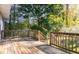 Wooden deck overlooking a wooded backyard, perfect for outdoor entertaining at 6945 Merrywood Dr, Fairburn, GA 30213