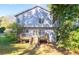 Exterior of home showing a walkout deck, a landscaped yard, and mature trees at 6945 Merrywood Dr, Fairburn, GA 30213