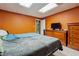 Bedroom features a bed with blue comforter, wood dresser, and a TV at , Fayetteville, GA 30215