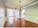 Dining area with hardwood floors and view of the living room and natural light at 6815 Fairgreen Dr, Suwanee, GA 30024