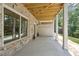 Back porch featuring stone, natural light, and a wooden ceiling at 1041 Endeavour Ct, Marietta, GA 30064