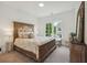 This elegant bedroom features a statement headboard and a picturesque window view at 1041 Endeavour Ct, Marietta, GA 30064