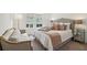 Bright bedroom featuring a tufted headboard, accent pillows, and a sitting area near a window at 1041 Endeavour Ct, Marietta, GA 30064