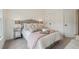 Bright bedroom featuring a tufted headboard, accent pillows, and mirrored nightstands at 1041 Endeavour Ct, Marietta, GA 30064