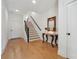 Hallway with hardwood floors, wooden stairs, and a decorative accent table at 1041 Endeavour Ct, Marietta, GA 30064