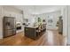 Bright kitchen with a stainless steel refrigerator, central island, and wood floors at 1041 Endeavour Ct, Marietta, GA 30064