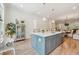 Bright kitchen featuring a blue island, stainless steel appliances, and hardwood floors at 1041 Endeavour Ct, Marietta, GA 30064