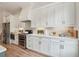 Stylish kitchen featuring white cabinets, stainless steel appliances, and a marble backsplash at 1041 Endeavour Ct, Marietta, GA 30064