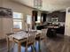 Bright dining area features a view of the modern kitchen with wood cabinets and stainless steel appliances at 307 Morning Frost, Canton, GA 30114