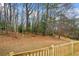 Expansive backyard with mature trees, offering a private and natural setting, viewed from the wooden deck at 3565 Collier Drive Nw Rd, Atlanta, GA 30331