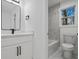 A modern, all-white bathroom with a walk-in shower and marble floors at 3565 Collier Drive Nw Rd, Atlanta, GA 30331