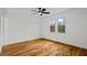 Bright bedroom featuring hardwood floors, modern ceiling fan and windows overlooking treetops at 3565 Collier Drive Nw Rd, Atlanta, GA 30331