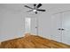 Bright bedroom featuring hardwood floors, a ceiling fan, and white trim and doors with black hardware at 3565 Collier Drive Nw Rd, Atlanta, GA 30331