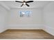 Bright bedroom featuring light wood floors, a ceiling fan, and two windows at 3565 Collier Drive Nw Rd, Atlanta, GA 30331