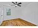 A well-lit bedroom featuring hardwood floors, white trim, and a ceiling fan at 3565 Collier Drive Nw Rd, Atlanta, GA 30331