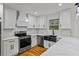 Bright kitchen with white cabinets, stainless steel appliances, and a modern sink, offering a clean and functional space at 3565 Collier Drive Nw Rd, Atlanta, GA 30331