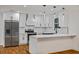 Modern kitchen features stainless steel appliances, white cabinetry, and a quartz countertop island with pendant lighting at 3565 Collier Drive Nw Rd, Atlanta, GA 30331