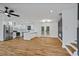 Open-concept living space with a modern kitchen, featuring white cabinets and stainless steel appliances at 3565 Collier Drive Nw Rd, Atlanta, GA 30331